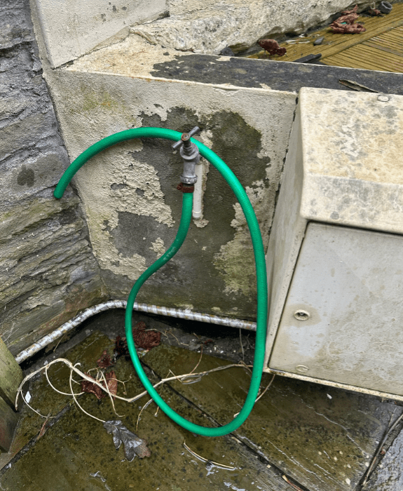 Outdoor hose for cleaning fishing gear, muddy boots, or dogs - practical amenity for countryside stays near Hay-on-Wye