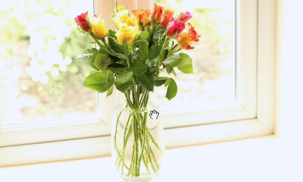 Fresh flowers by the bathroom window at The Hay Holiday Cottage