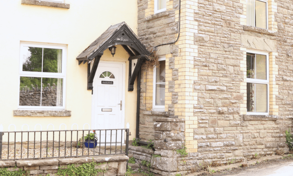 Welcoming front door and stone exterior of The Hay Holiday Cottage in Hay-on-Wye – traditional charm meets countryside comfort